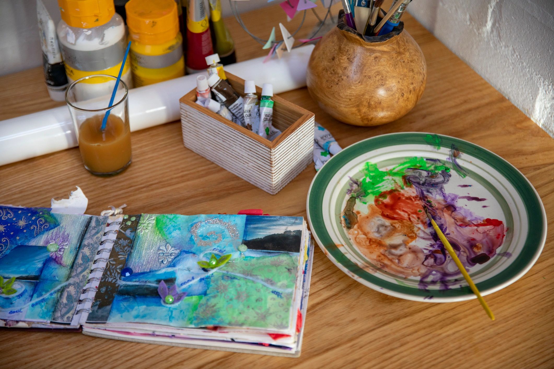 Sketchpad and paint on a studio workbench