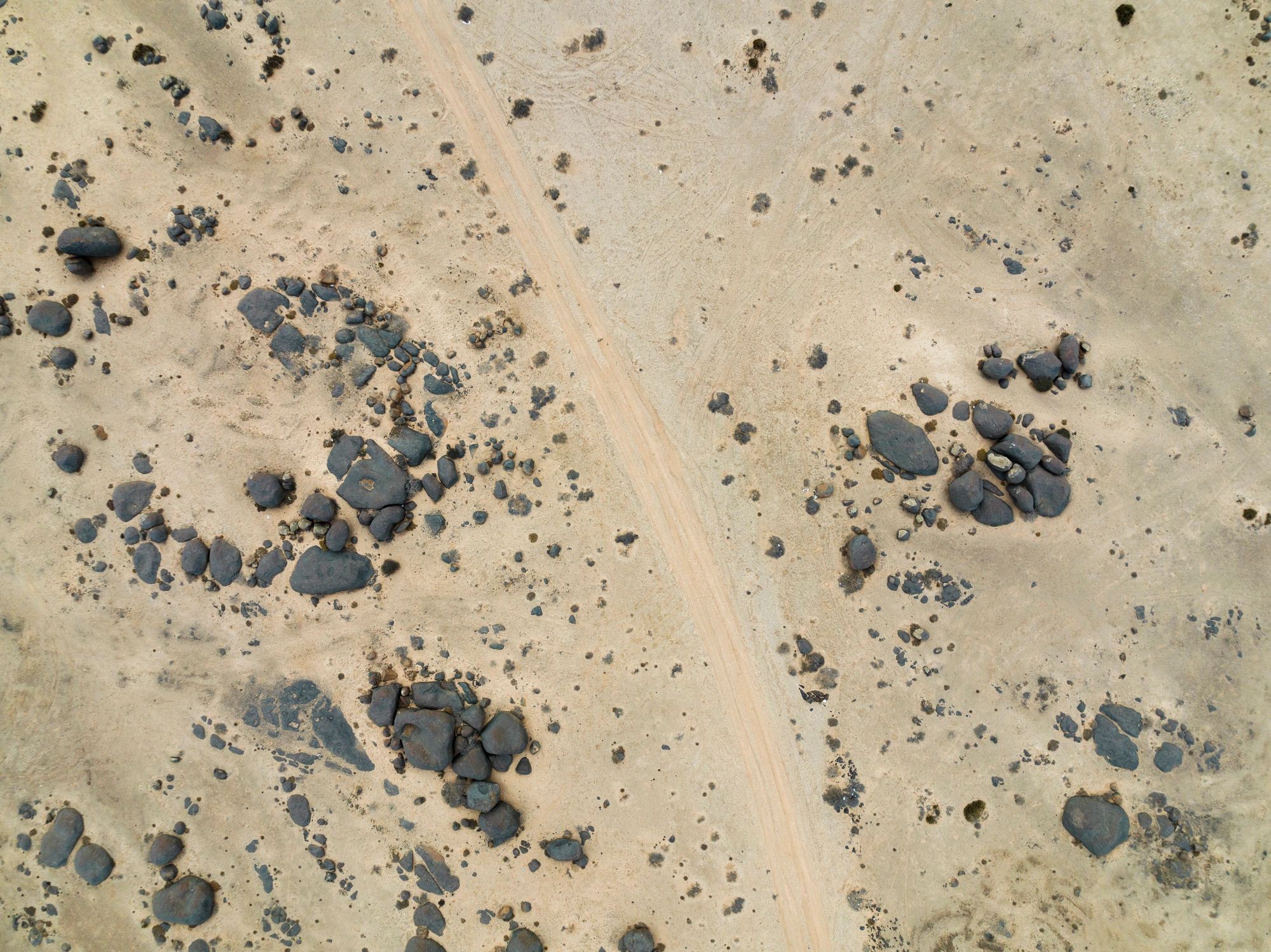 Sandy road through a rocky desert