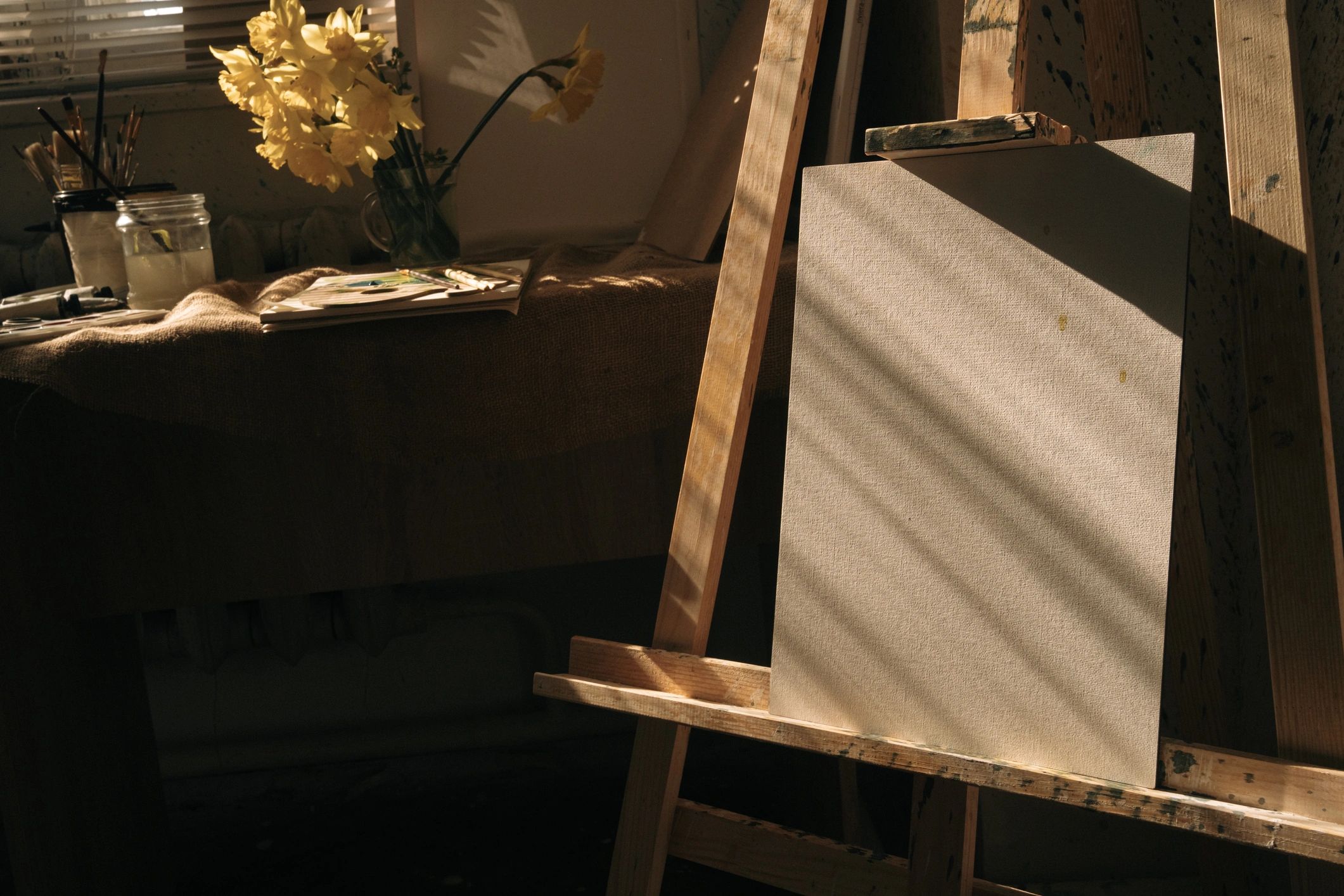 Artist easel in sunlit studio interior